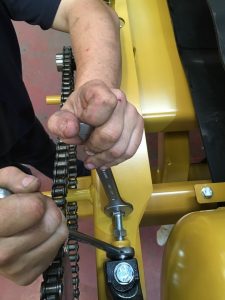 A close-up of a person's hands holding a wrench<br><br>Description automatically generated with low confidence